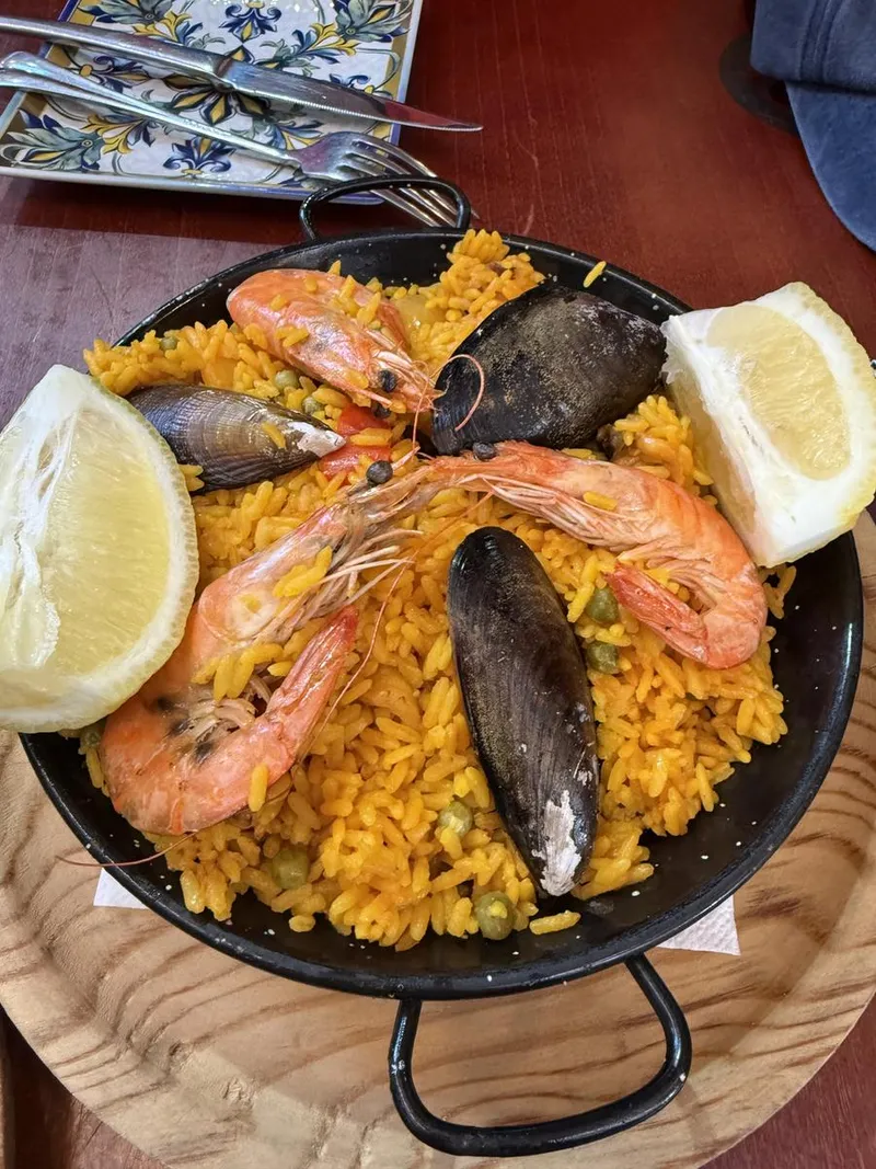 A seafood paella with prawns, mussels and lemon, photographed by a guest at Taberna Picas Málaga