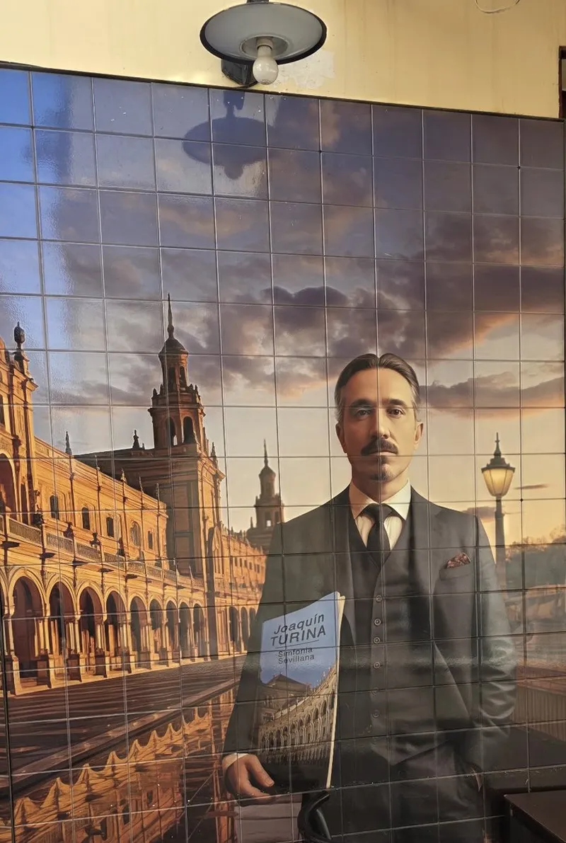 Tile mural in the passage: a composer in a three-piece suit holding a score in front of a monumental square at sunset